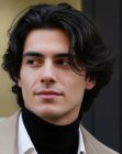 Un homme aux cheveux foncés, coiffés-décoiffés